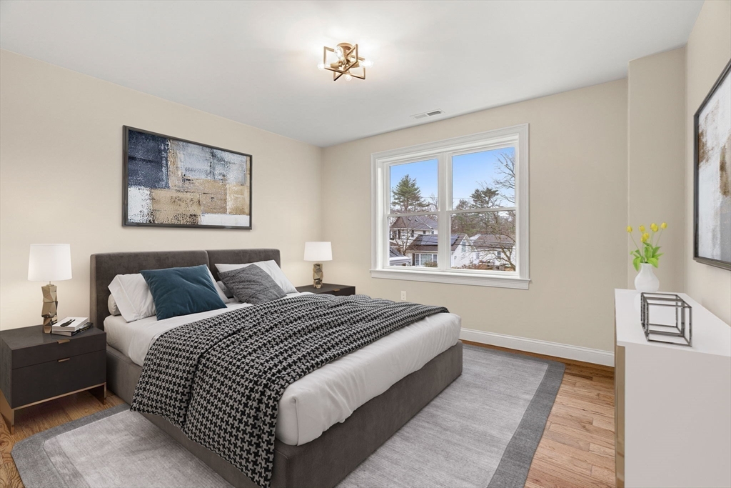 40 Boston Road Andover, MA 01810 - Photo 22 of 42 a bedroom with bed and a painting on the wall