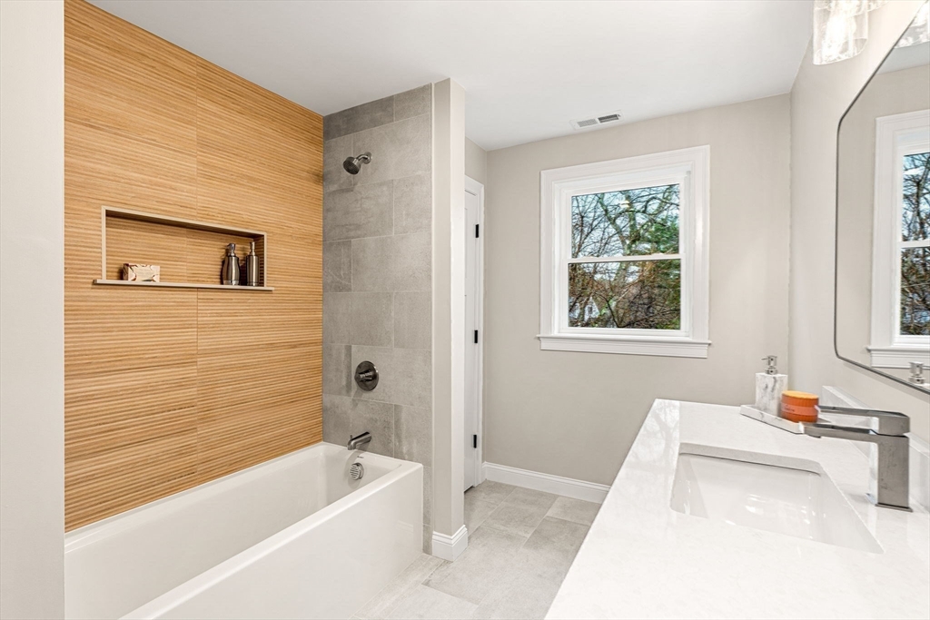 40 Boston Road Andover, MA 01810 - Photo 23 of 42 a bathroom with a tub a sink and a window