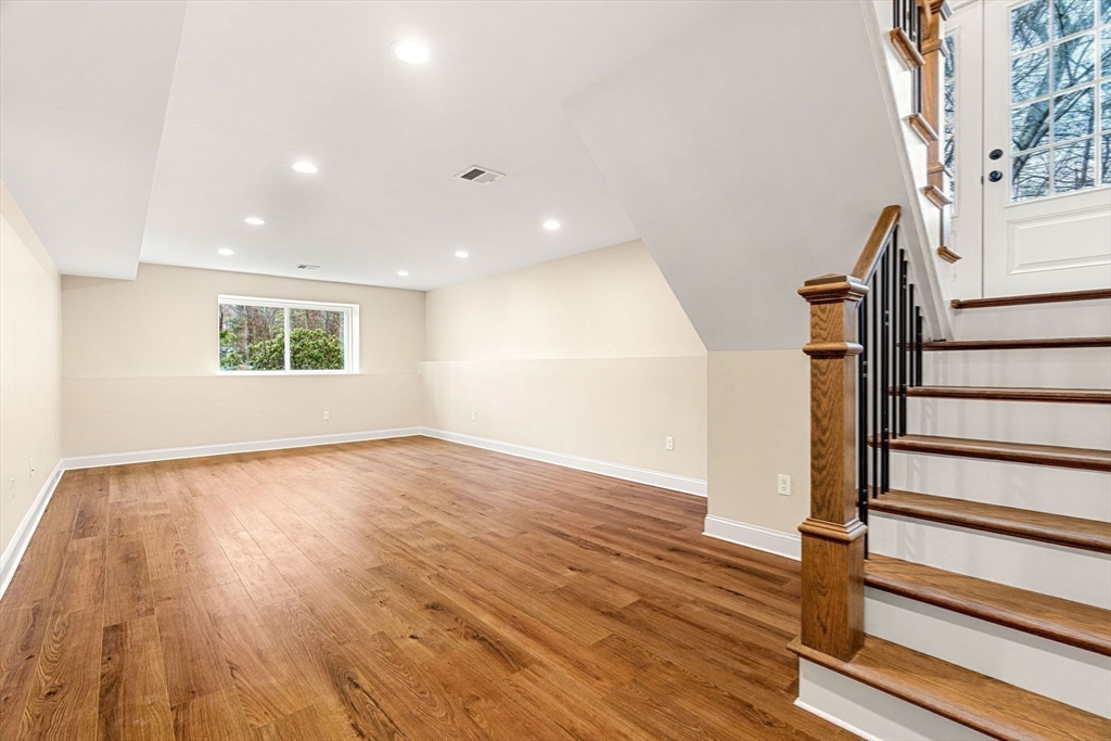 40 Boston Road Andover, MA 01810 - Photo 27 of 42 a view of an empty room with wooden floor and stairs