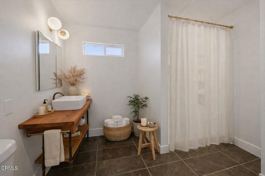 61714 Commercial Street Joshua Tree, CA 92252 - Photo 14 of 42 a bathroom with a toilet a sink and mirror