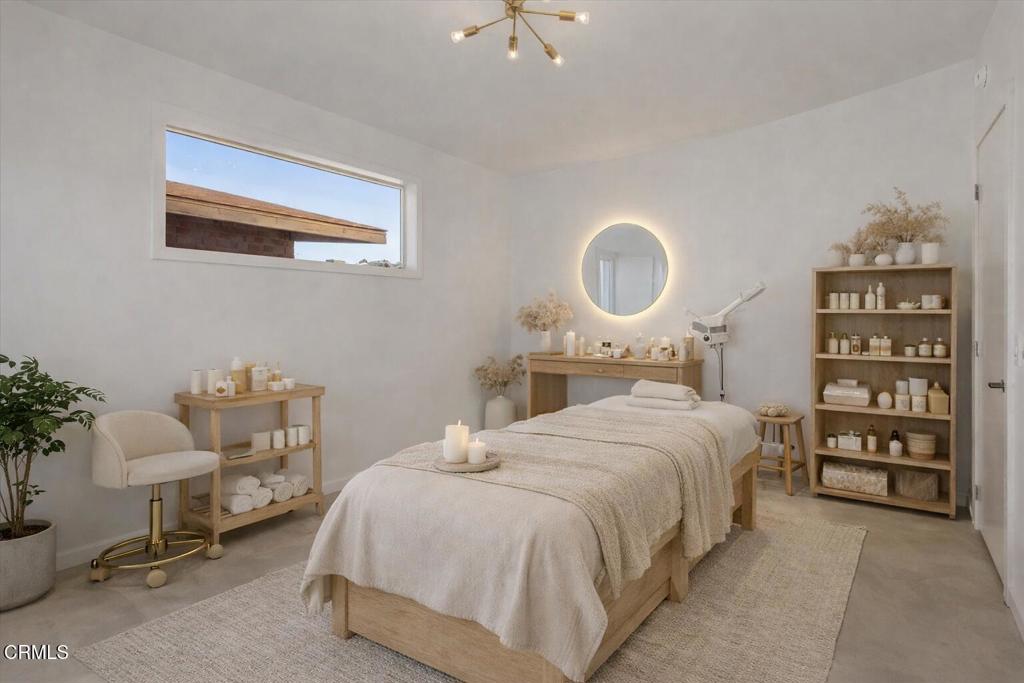 61714 Commercial Street Joshua Tree, CA 92252 - Photo 19 of 42 a bedroom with a bed and a chandelier