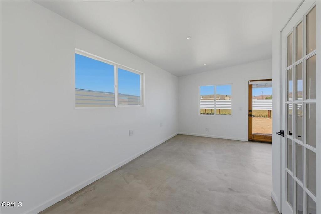 61714 Commercial Street Joshua Tree, CA 92252 - Photo 21 of 42 an empty room with windows