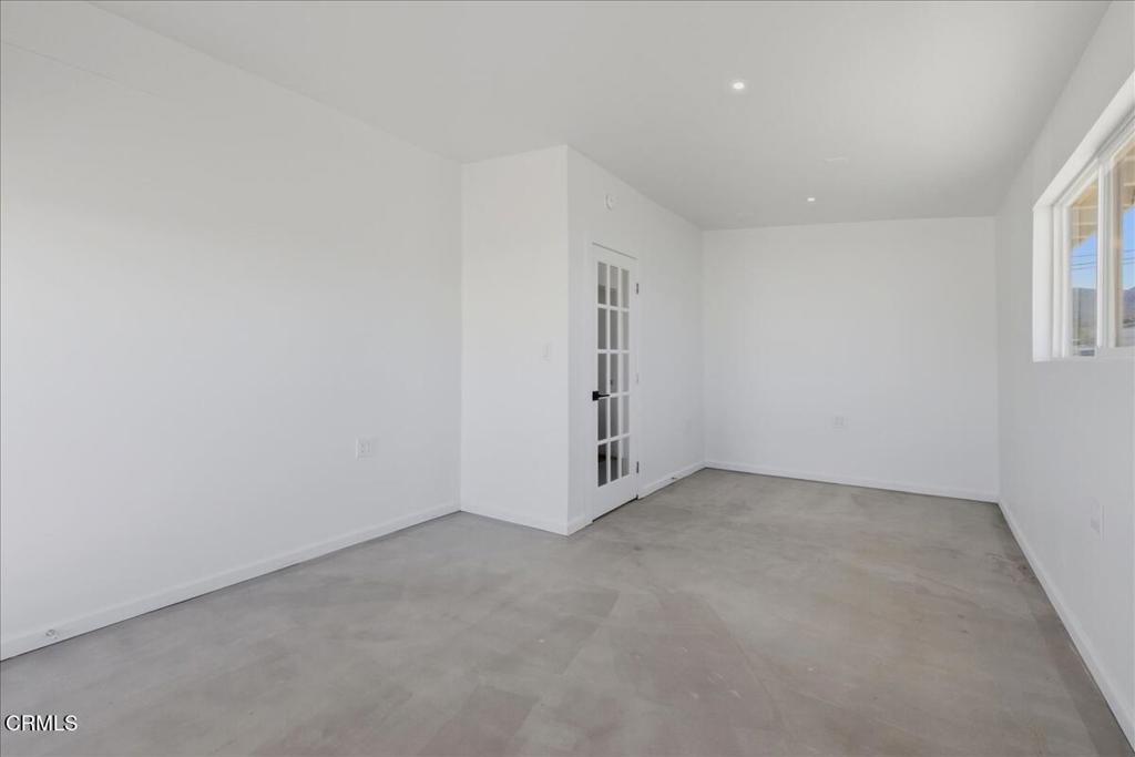 61714 Commercial Street Joshua Tree, CA 92252 - Photo 22 of 42 an empty room with windows