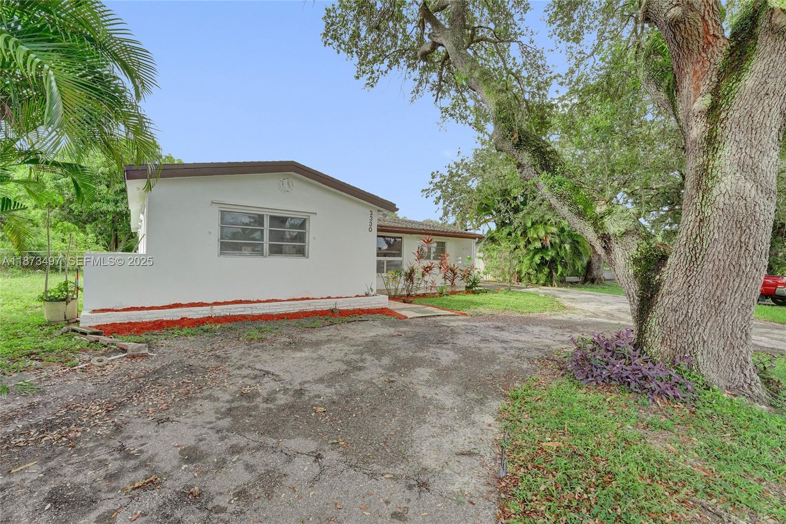 3330 Taft Street Hollywood, FL 33021 - Photo 11 of 70 a view of a house with yard and tree s