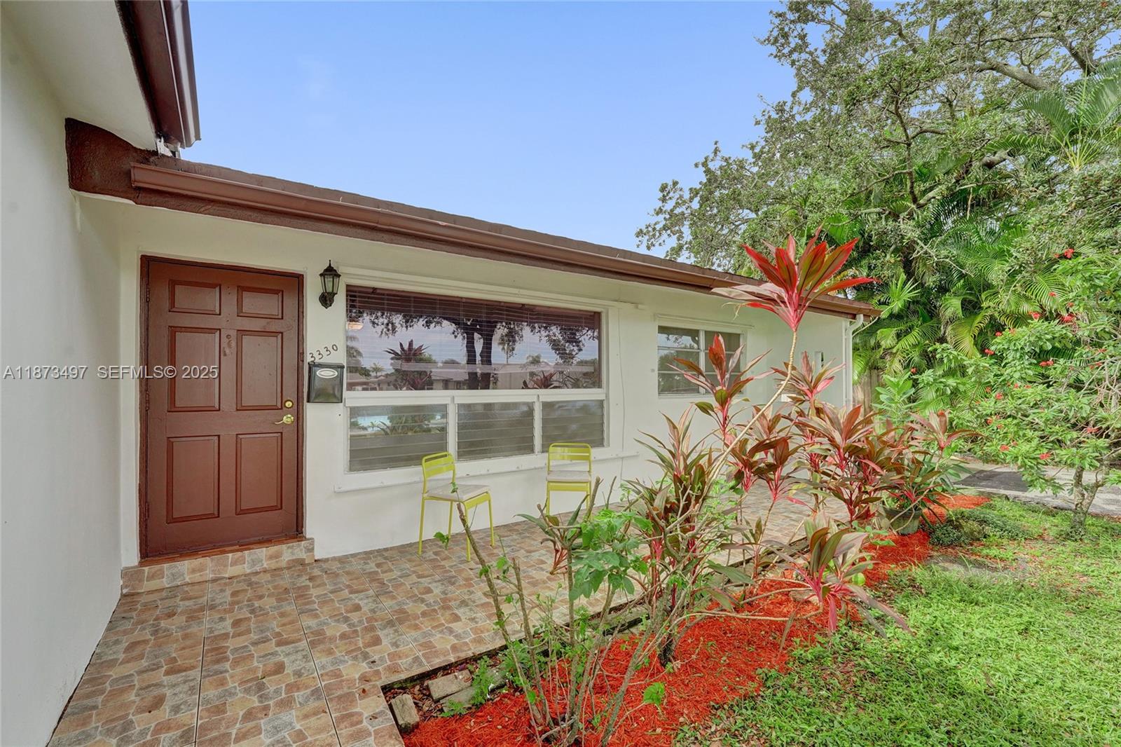 3330 Taft Street Hollywood, FL 33021 - Photo 12 of 70 front view of a house with a small yard