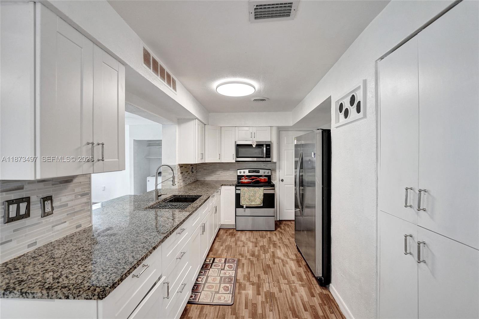 3330 Taft Street Hollywood, FL 33021 - Photo 2 of 70 a kitchen with stainless steel appliances granite countertop a refrigerator and a stove top oven