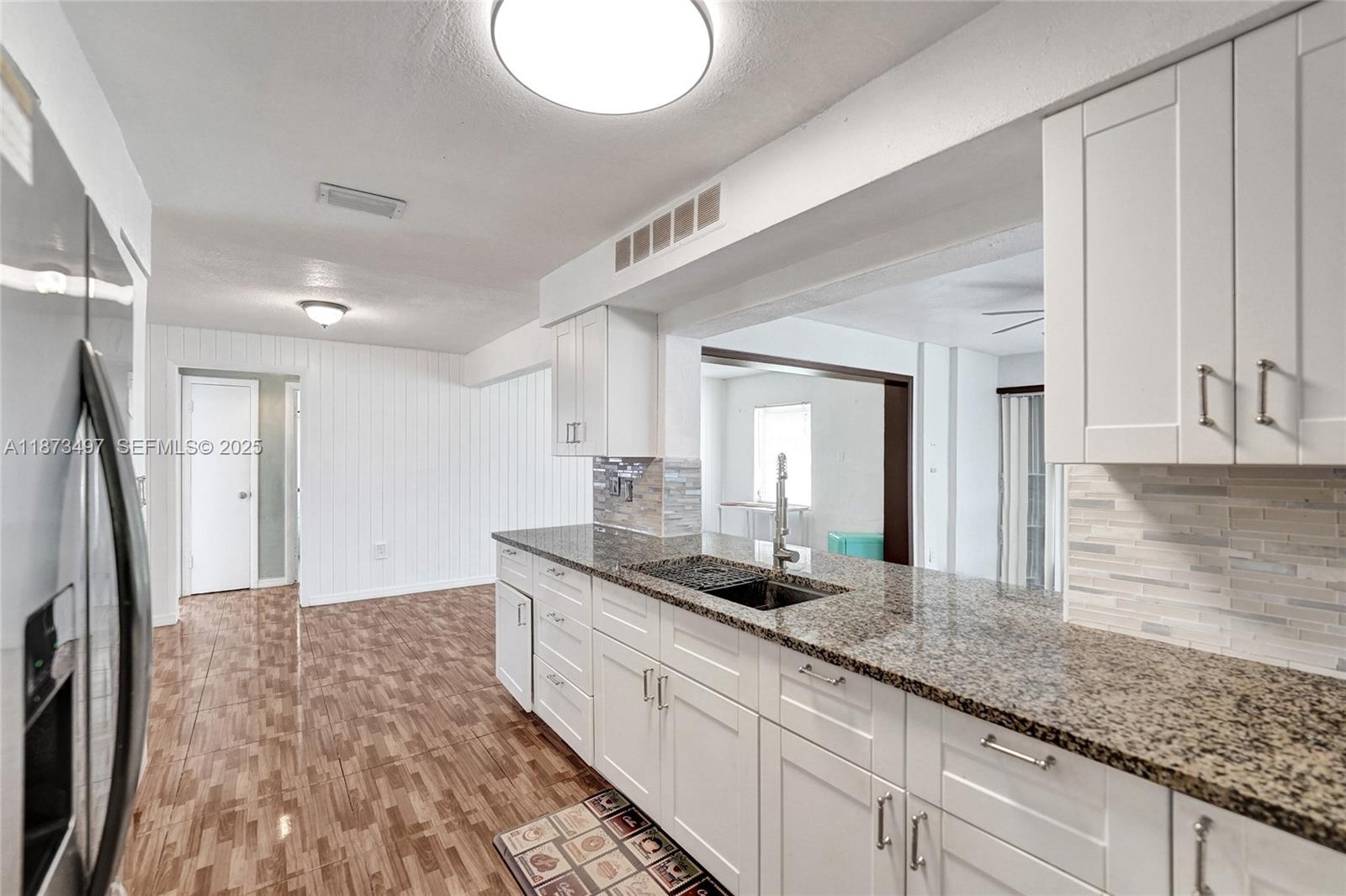 3330 Taft Street Hollywood, FL 33021 - Photo 29 of 70 a bathroom with a granite countertop sink and a mirror