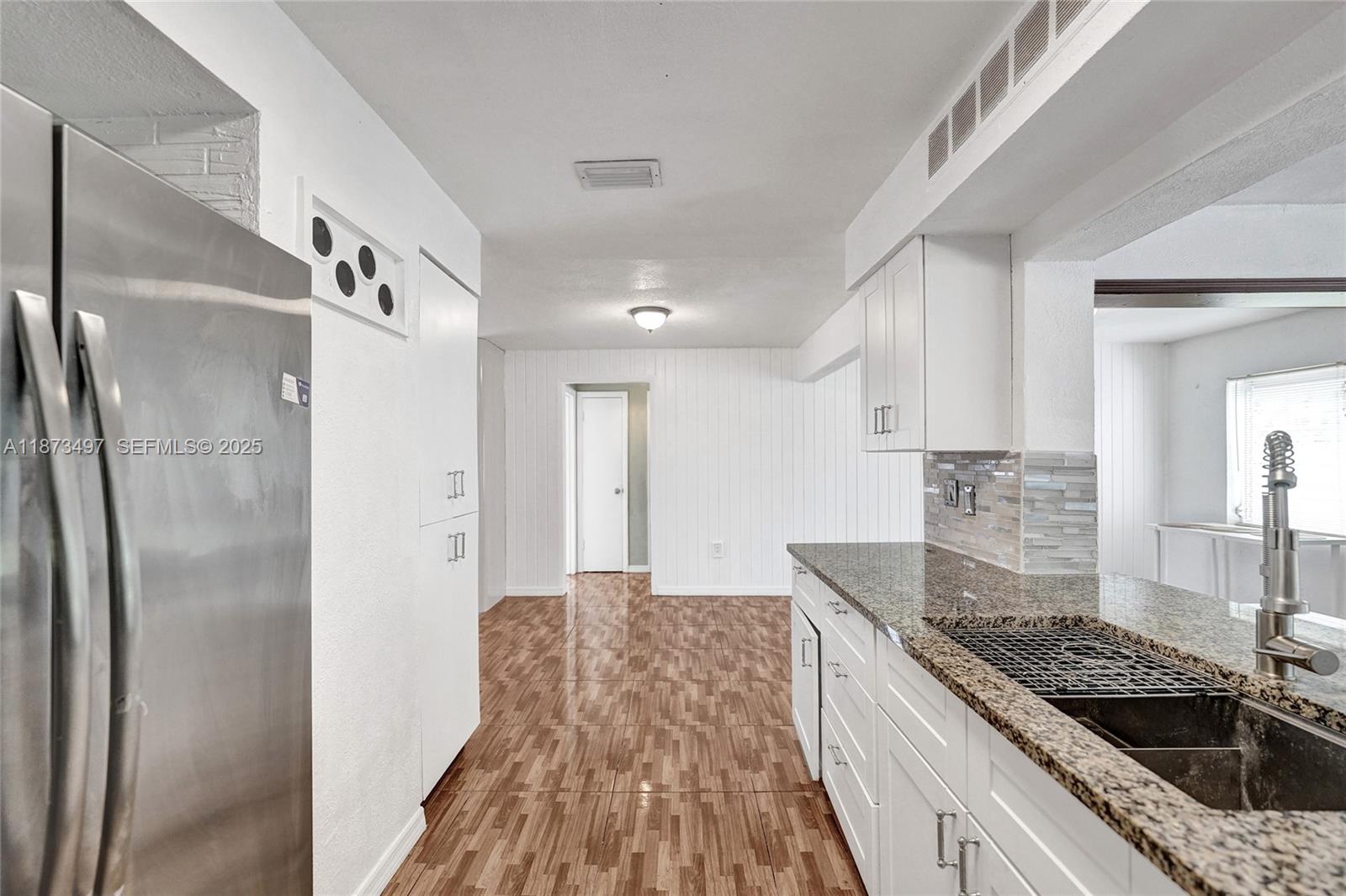 3330 Taft Street Hollywood, FL 33021 - Photo 30 of 70 a kitchen with stainless steel appliances granite countertop a sink stove and refrigerator
