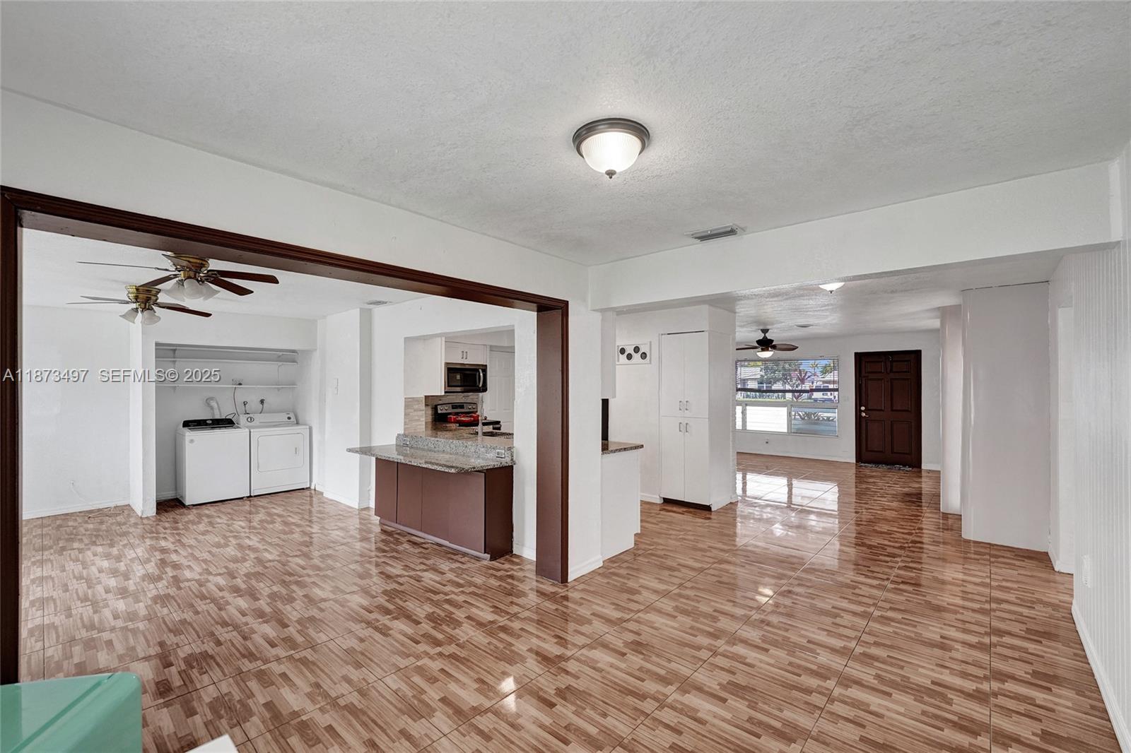 3330 Taft Street Hollywood, FL 33021 - Photo 34 of 70 a view of a open kitchen with a sink and a refrigerator