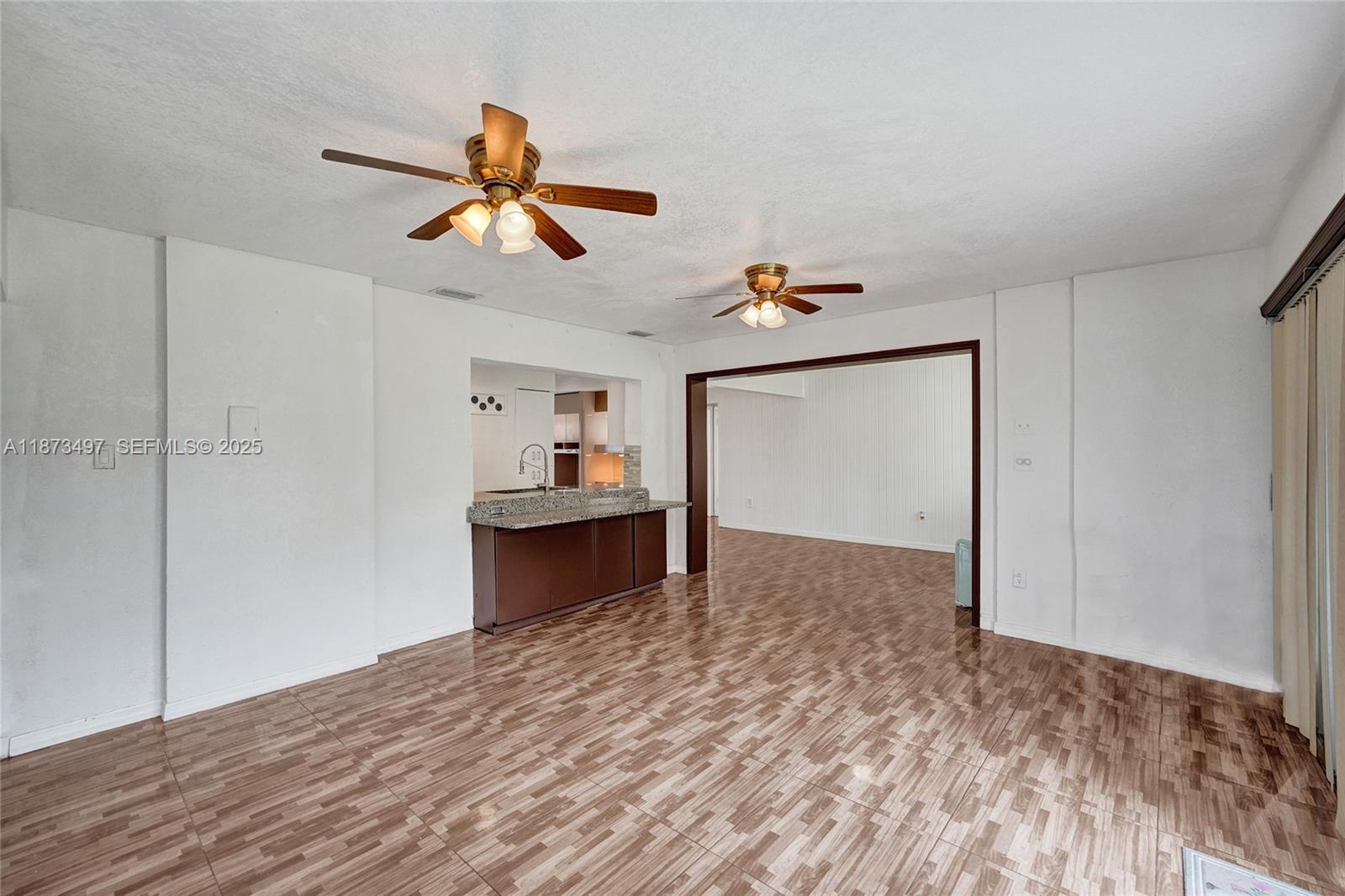 3330 Taft Street Hollywood, FL 33021 - Photo 37 of 70 a view of kitchen and empty room with wooden floor