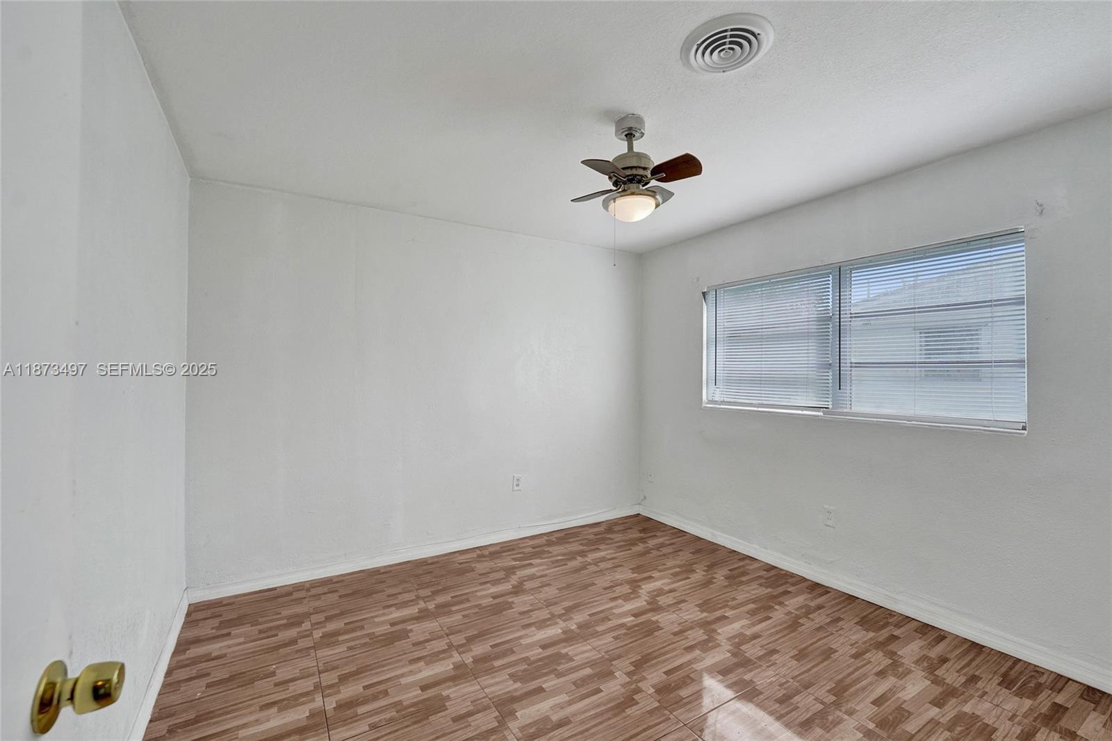 3330 Taft Street Hollywood, FL 33021 - Photo 39 of 70 a view of a room with a ceiling fan and a window