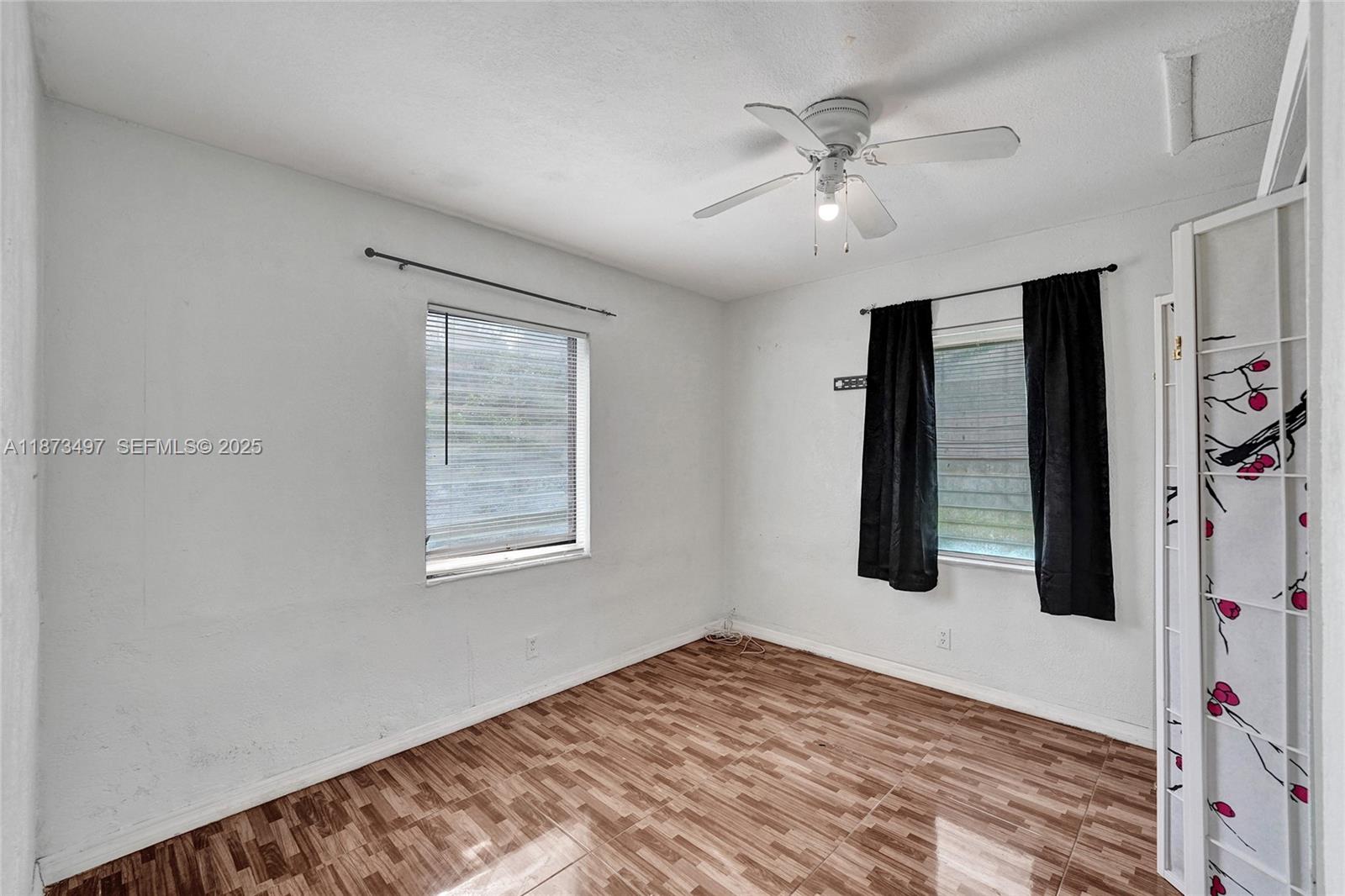 3330 Taft Street Hollywood, FL 33021 - Photo 46 of 70 a view of a bedroom with a ceiling fan and a window