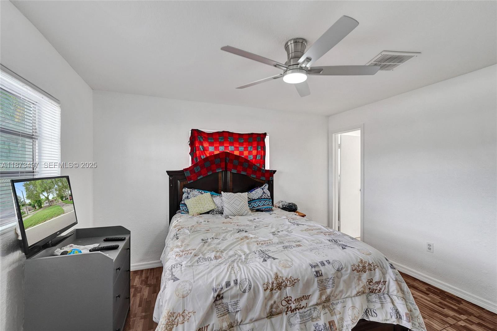 3330 Taft Street Hollywood, FL 33021 - Photo 50 of 70 a bedroom with a bed and a chandelier