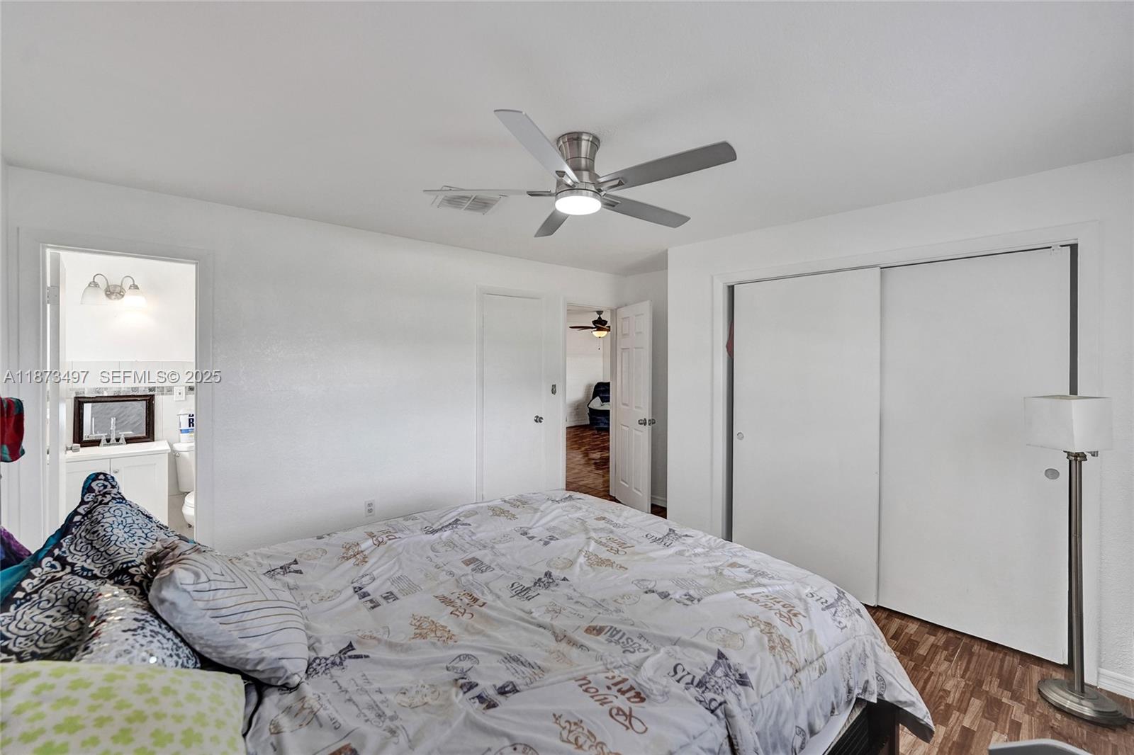 3330 Taft Street Hollywood, FL 33021 - Photo 51 of 70 a bedroom with a bed and a chandelier