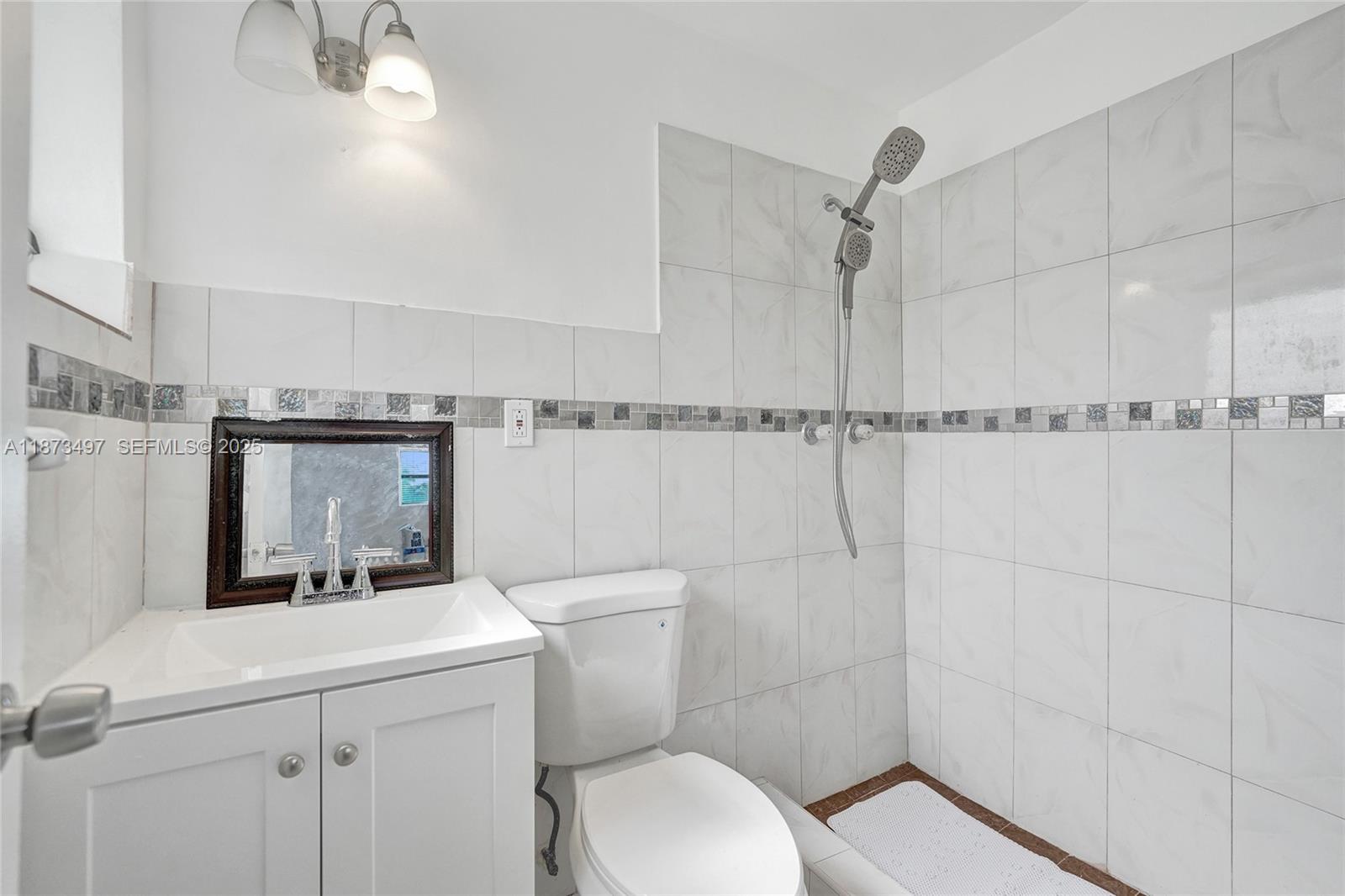 3330 Taft Street Hollywood, FL 33021 - Photo 53 of 70 a bathroom with a toilet a sink and shower