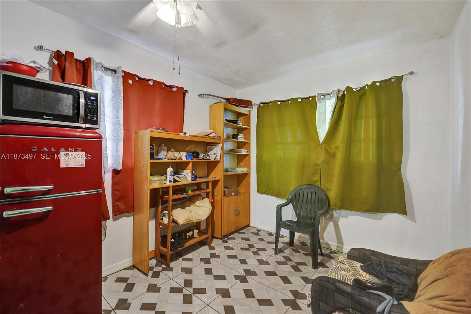 3330 Taft Street Hollywood, FL 33021 - Photo 56 of 70 a living room with a couch and a chandelier