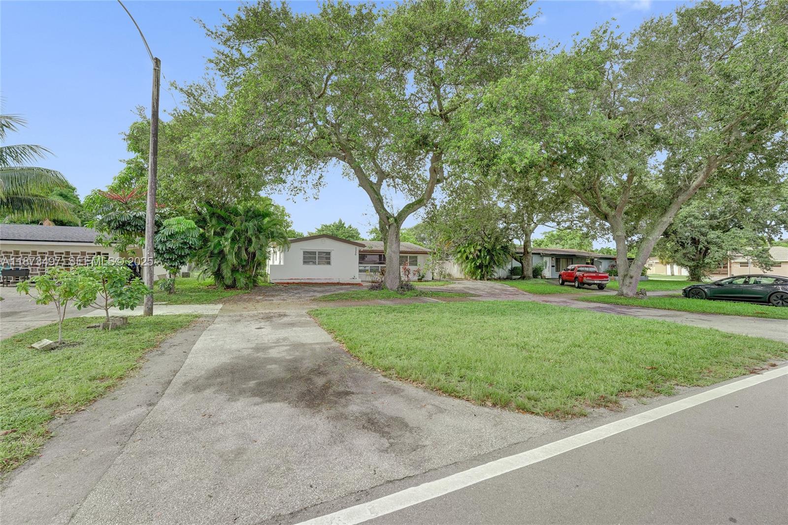 3330 Taft Street Hollywood, FL 33021 - Photo 6 of 70 a green field with lots of trees in the background