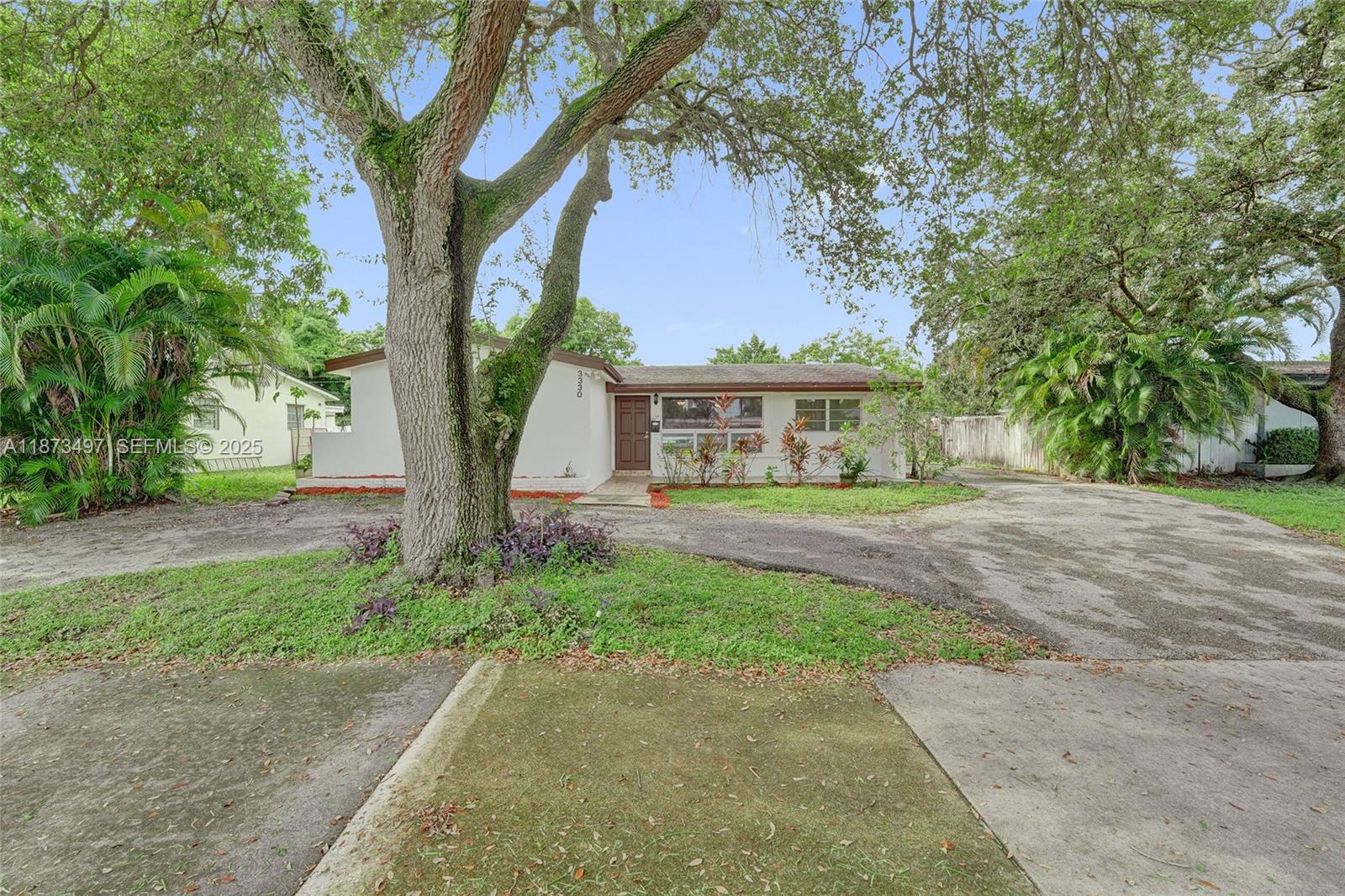 3330 Taft Street Hollywood, FL 33021 - Photo 8 of 70 a front view of a house with yard and green space