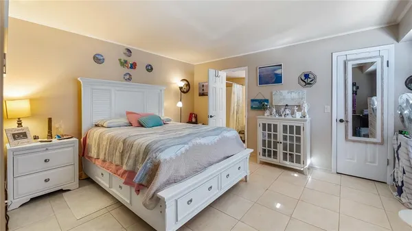 a spacious bedroom with a bed and a window