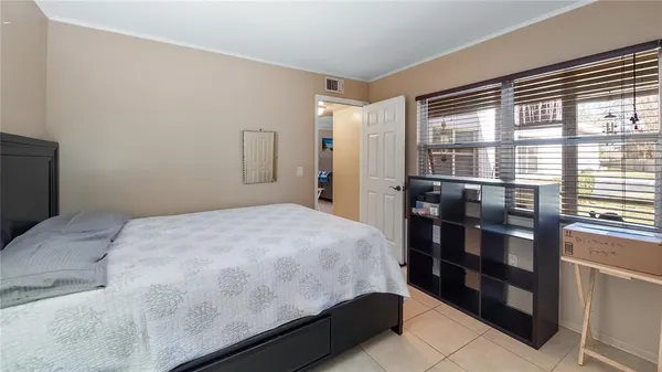 a bedroom with a bed and a window