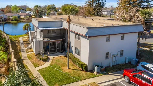 a view of a house with pool and chairs