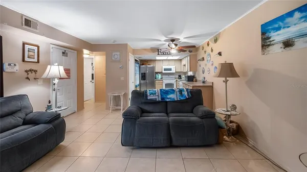 a living room with furniture and a chandelier