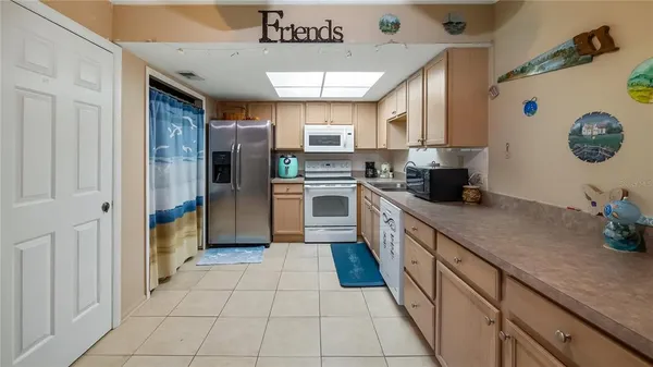 a kitchen with a sink a refrigerator and washer