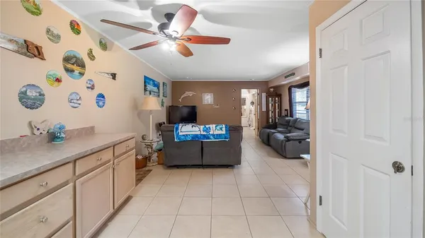 a large white kitchen with a large window and stainless steel appliances