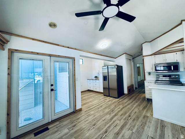 150 North 3050 East, Unit 4 St. George, UT 84790 - Photo 6 of 24 Kitchen area with wood-finish flooring and white cabinetry