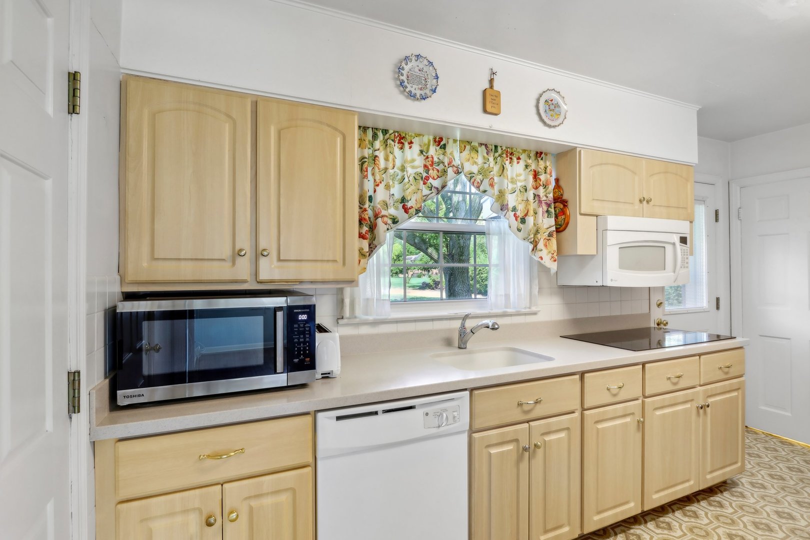 10 North Elmhurst Road Prospect Heights, IL 60070 - Photo 11 of 50 a kitchen with stainless steel appliances white cabinets and a window