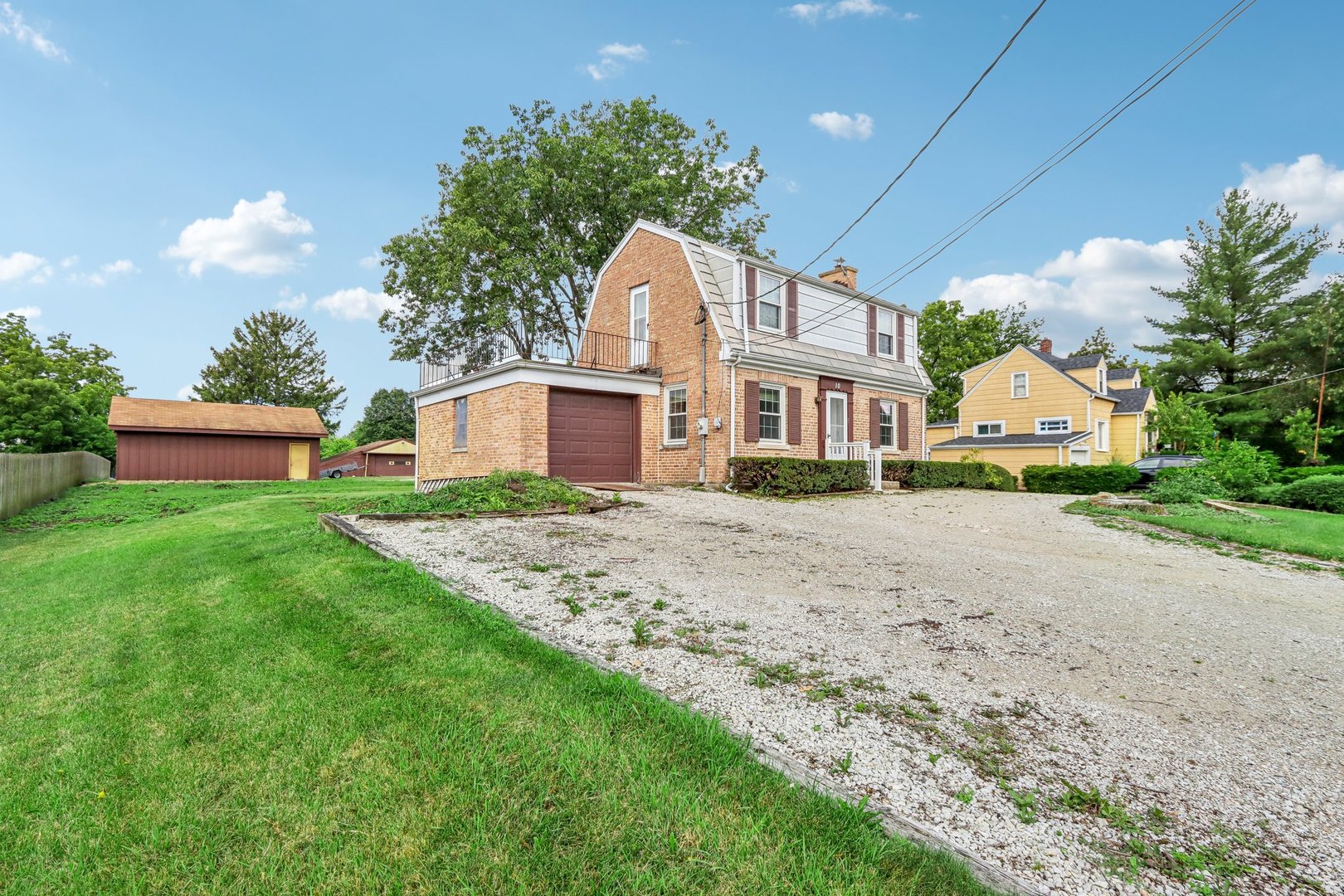 10 North Elmhurst Road Prospect Heights, IL 60070 - Photo 30 of 50 a view of a white house next to a yard with potted plants