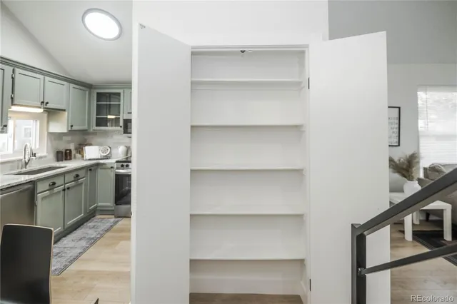 a kitchen with a refrigerator and white cabinets
