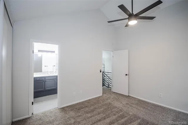 an empty room with closet and fan