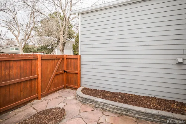 a wooden bench sitting in front of a house