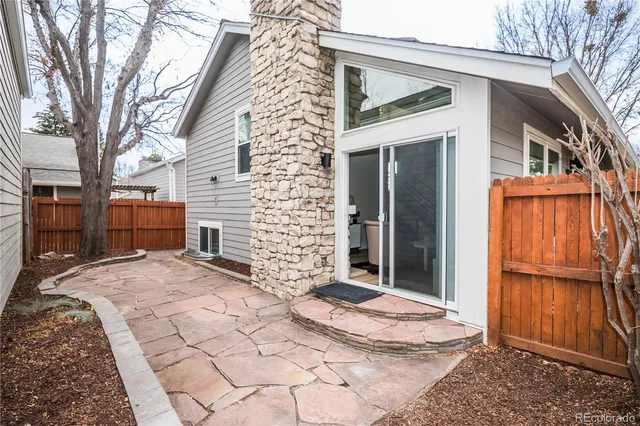 a view of a house with a door and wooden walls