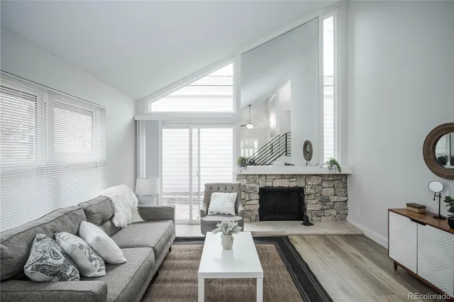 a living room with furniture a window and a fireplace