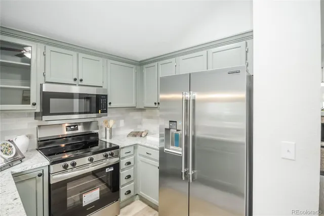 a kitchen with a refrigerator stove and microwave