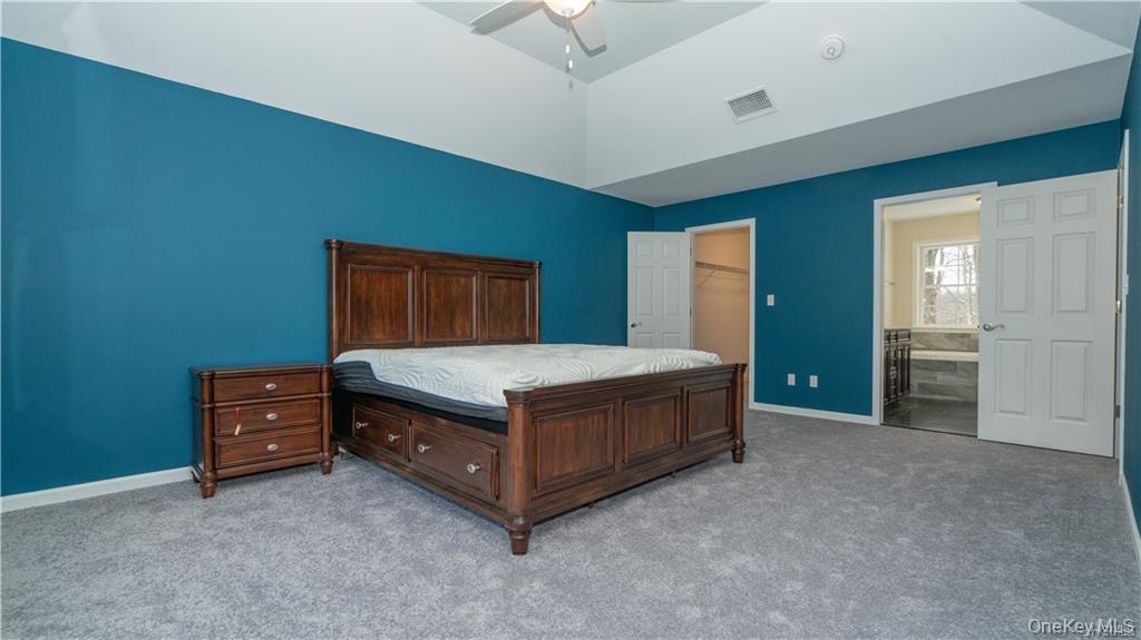 5 Harrier Ridge Drive Wallkill, NY 12589 - Photo 14 of 33 Carpeted bedroom with a walk in closet, a ceiling fan, and lofted ceiling