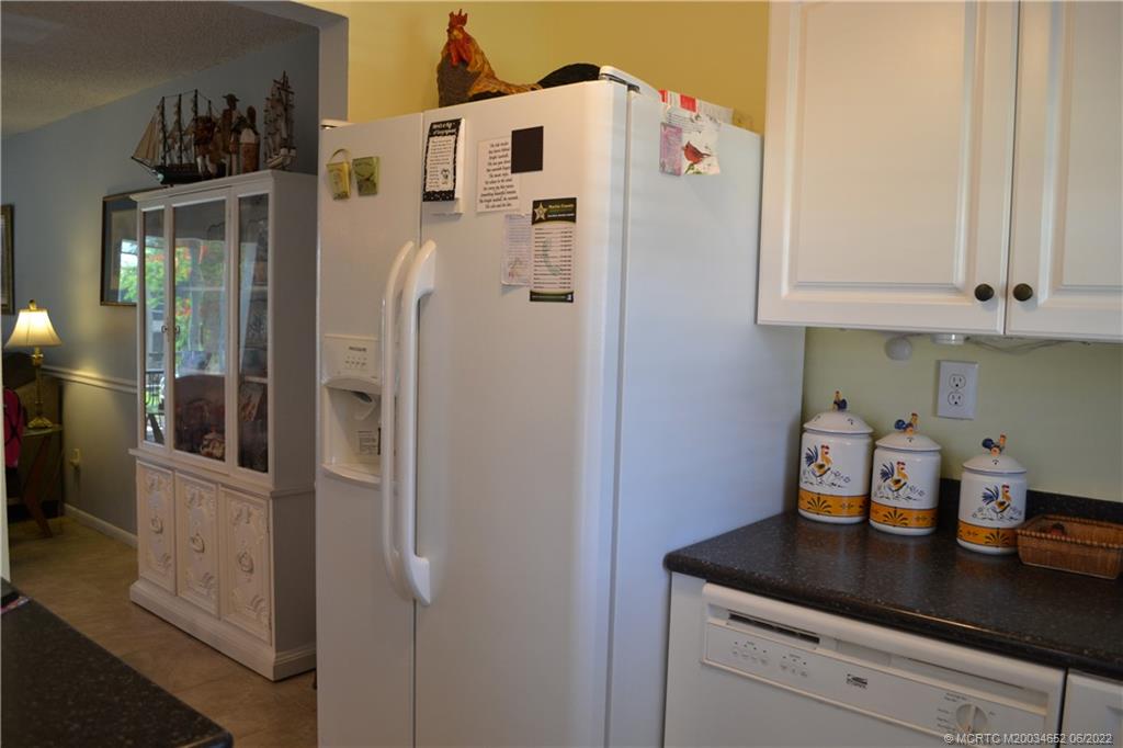 1969 Southwest Palm City Road, Unit G Stuart, FL 34994 - Photo 14 of 76 a kitchen with stainless steel appliances a refrigerator and cabinets