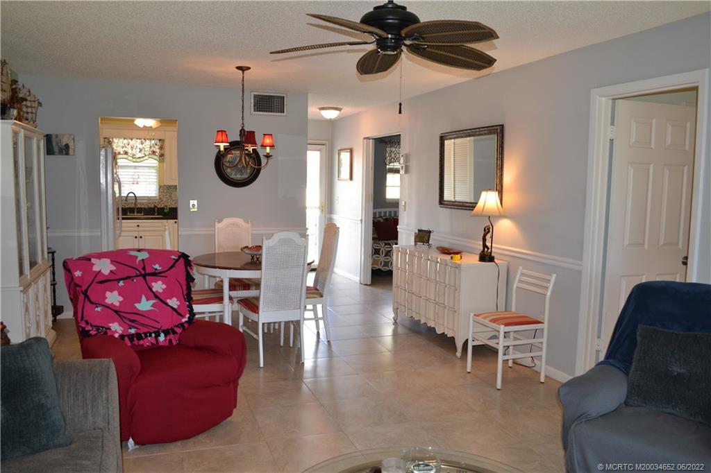 1969 Southwest Palm City Road, Unit G Stuart, FL 34994 - Photo 21 of 76 a living room with furniture a flat screen tv and a window