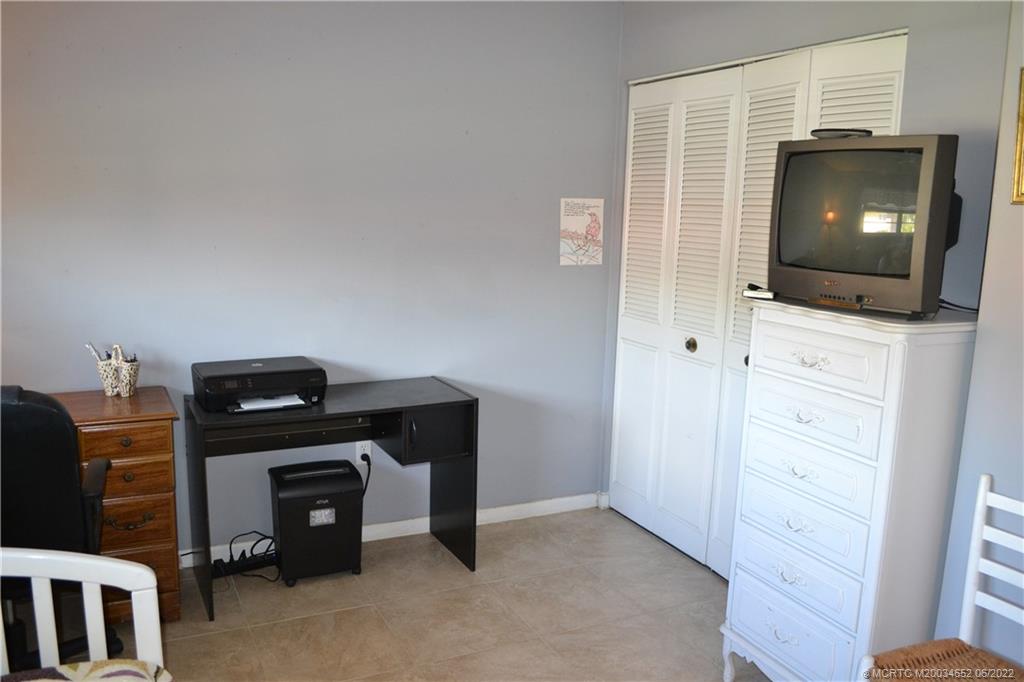 1969 Southwest Palm City Road, Unit G Stuart, FL 34994 - Photo 35 of 76 a living room with furniture and a flat screen tv