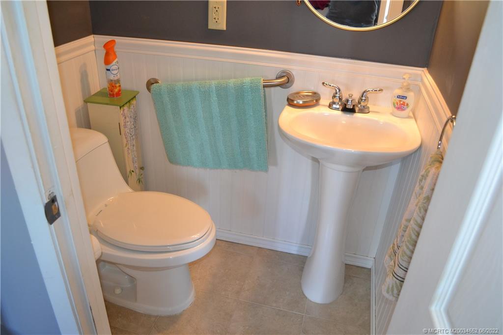 1969 Southwest Palm City Road, Unit G Stuart, FL 34994 - Photo 36 of 76 a bathroom with a sink and toilet