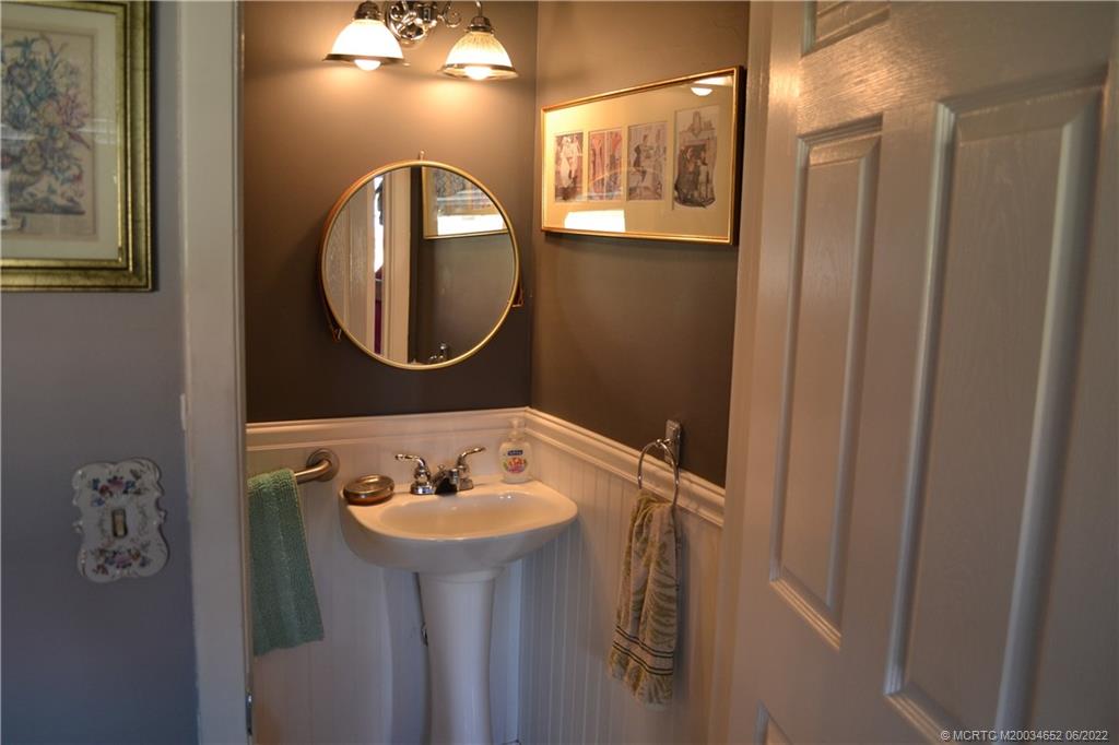 1969 Southwest Palm City Road, Unit G Stuart, FL 34994 - Photo 37 of 76 a bathroom with a sink and a mirror