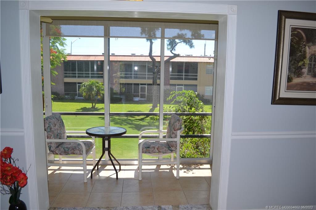 1969 Southwest Palm City Road, Unit G Stuart, FL 34994 - Photo 38 of 76 a view of a porch with chairs and backyard