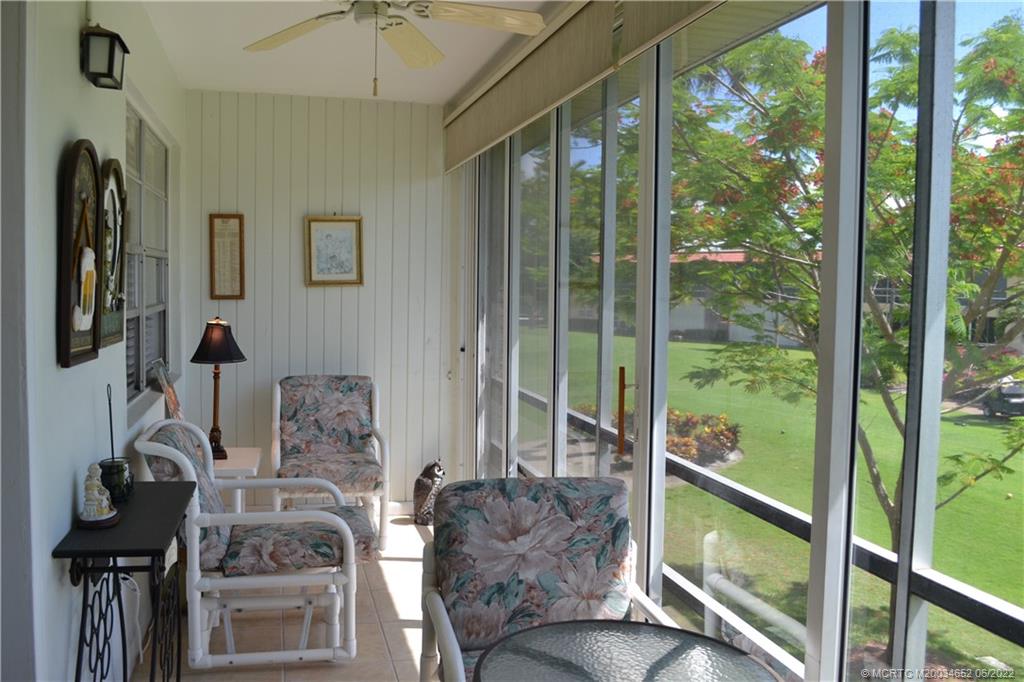 1969 Southwest Palm City Road, Unit G Stuart, FL 34994 - Photo 40 of 76 a living room with furniture and a floor to ceiling window