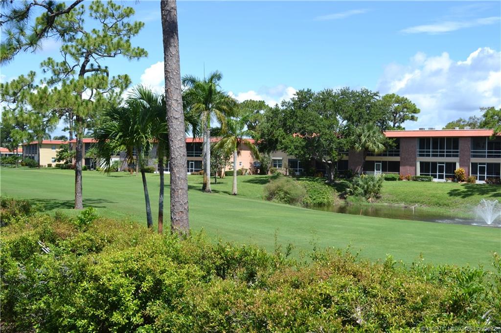 1969 Southwest Palm City Road, Unit G Stuart, FL 34994 - Photo 45 of 76 a view of a house with a backyard and a tree