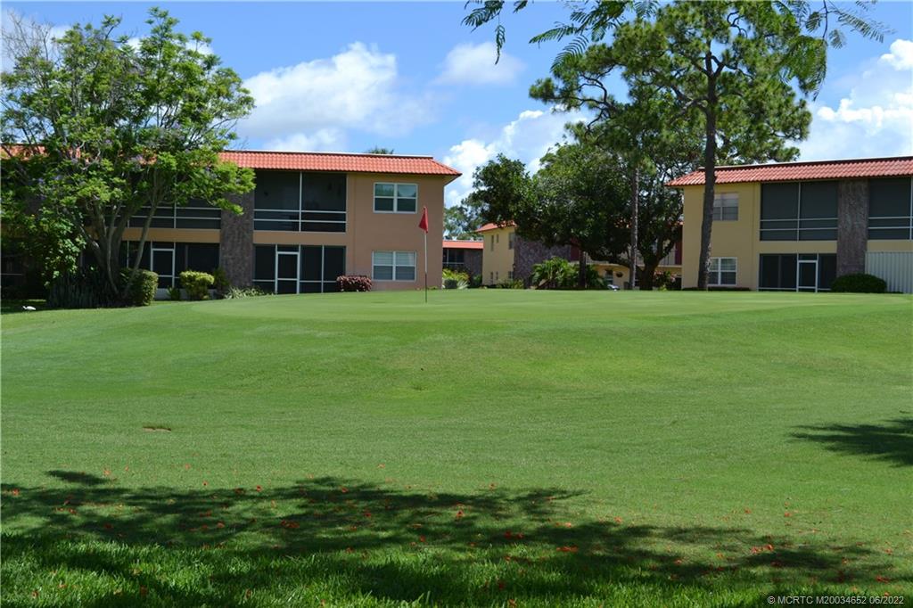 1969 Southwest Palm City Road, Unit G Stuart, FL 34994 - Photo 47 of 76 a front view of a house with a garden