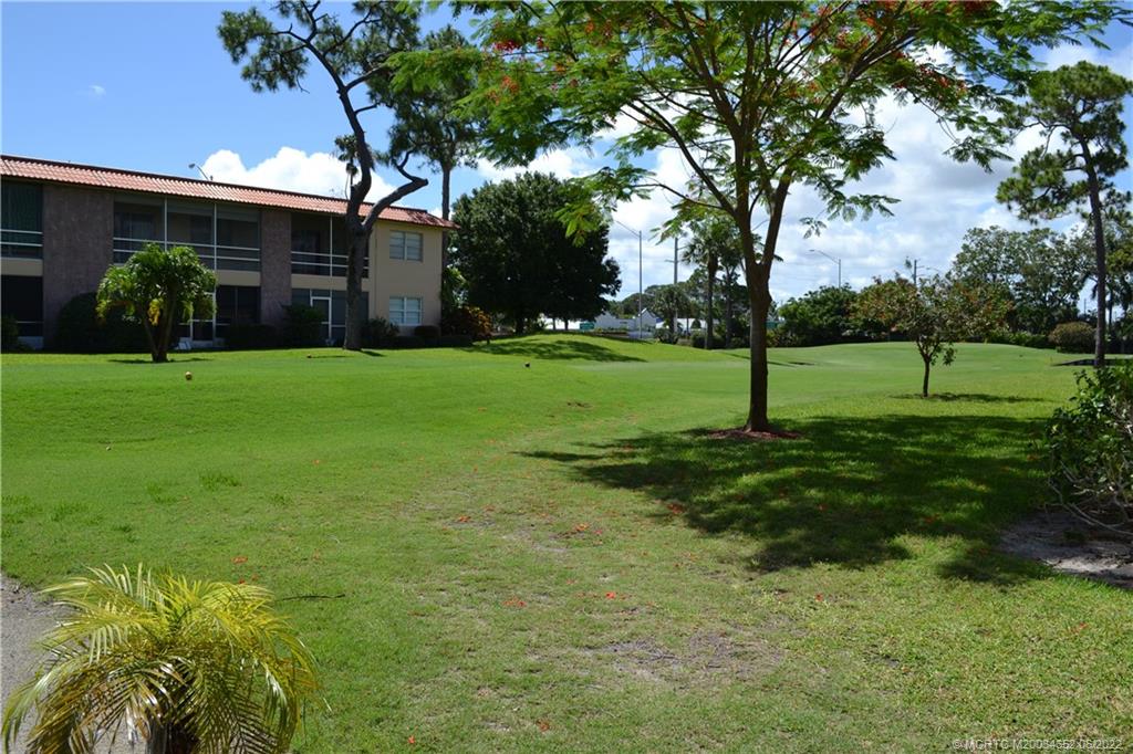 1969 Southwest Palm City Road, Unit G Stuart, FL 34994 - Photo 48 of 76 a view of a backyard with large trees