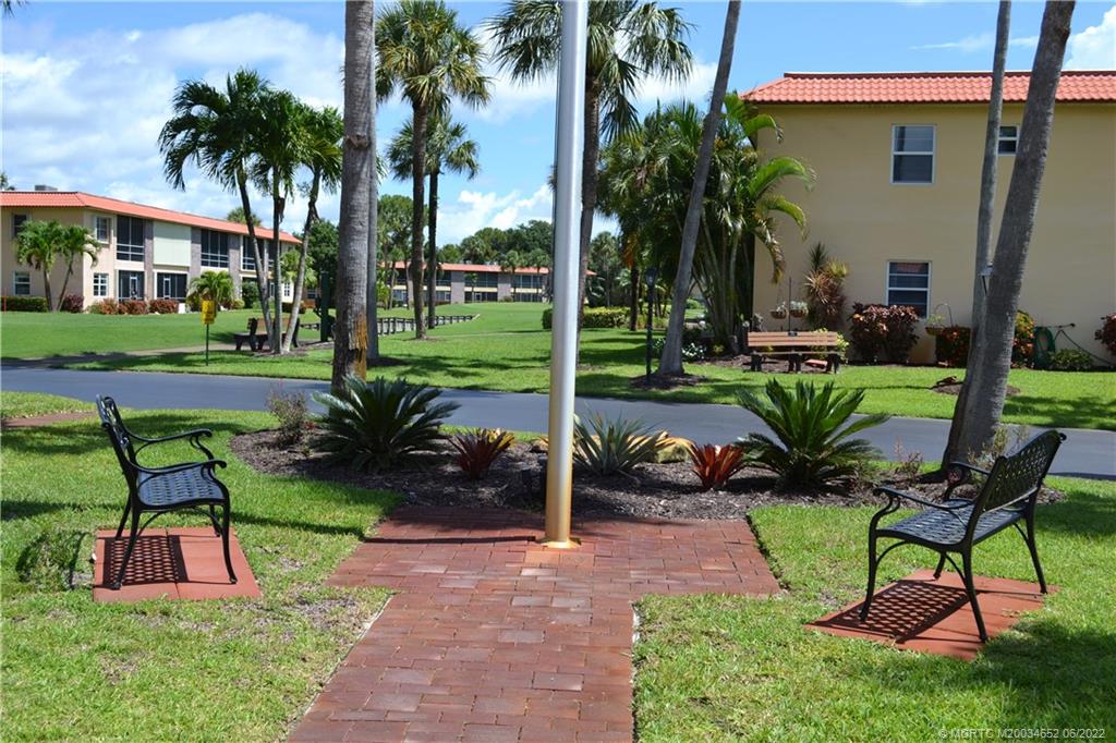 1969 Southwest Palm City Road, Unit G Stuart, FL 34994 - Photo 54 of 76 a view of a table and chairs in the garden