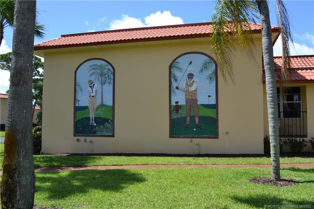 1969 Southwest Palm City Road, Unit G Stuart, FL 34994 - Photo 55 of 76 a front view of a house with garden